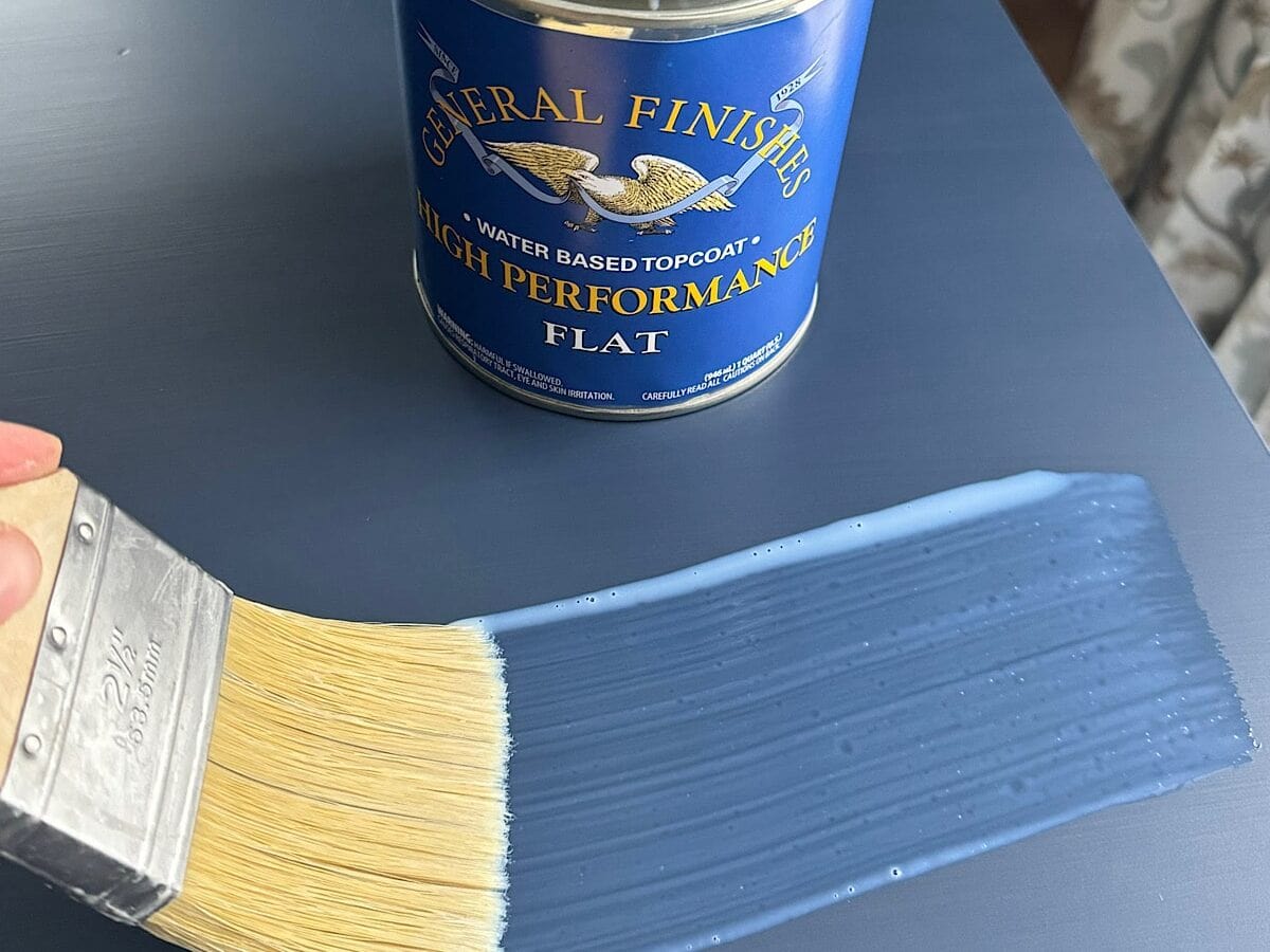 Image of a person brushing on a coat of General Finishes High Performance Topcoat with a Zibra topcoat brush.