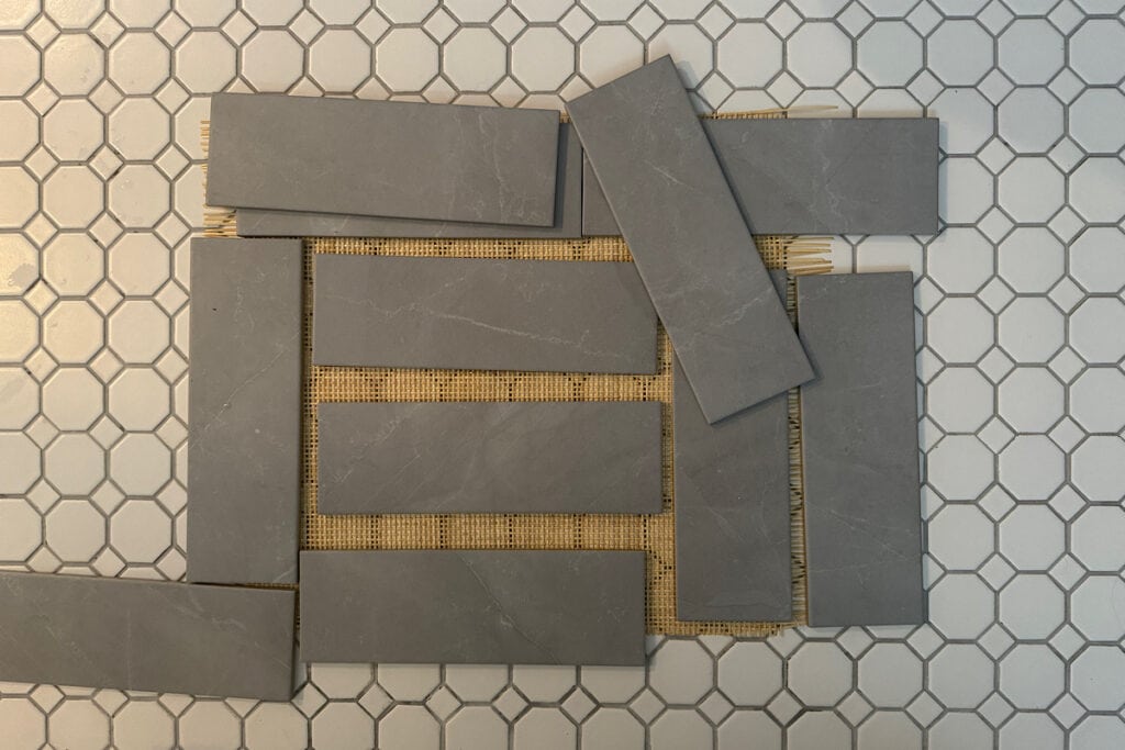 Cane webbing drying on a tile floor with tiles as weights to keep it flat.