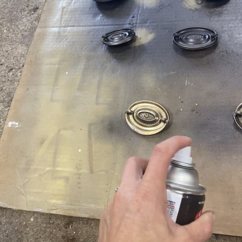 Using spray paint to refinish furniture hardware.