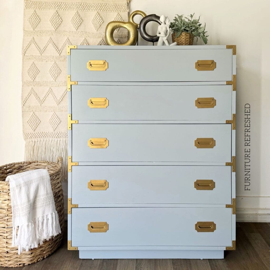 After photo of the 5 drawer dresser used in this makeover. It is a Dixie Furniture Campaigner style, painted light blue with gold hardware.