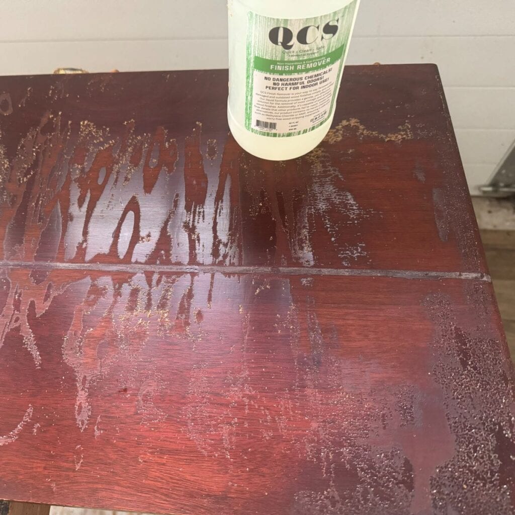 photo of the table top after being stripped with QCS and cleaned. A significant amount of the finish remains.