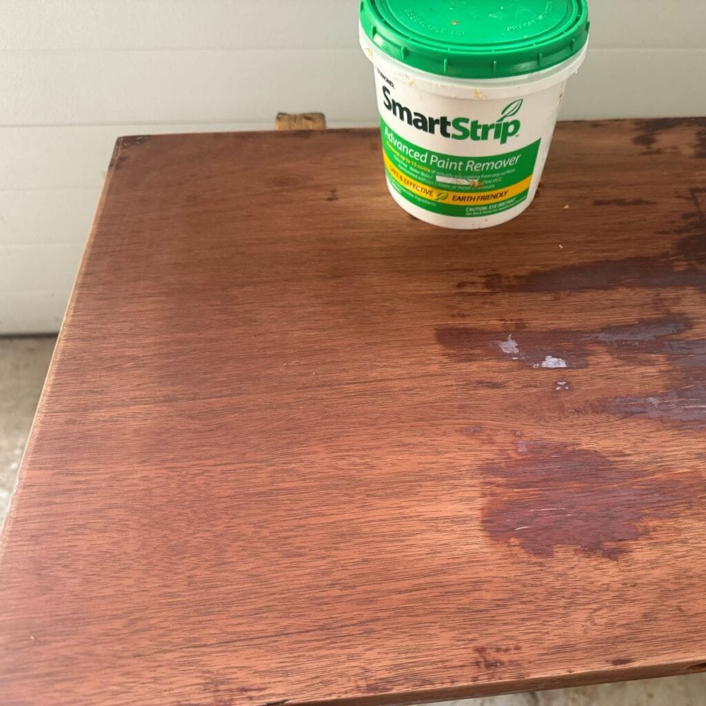 photo of the table top after being stripped with Smart Strip and cleaned. Most of the existing finish has been removed.