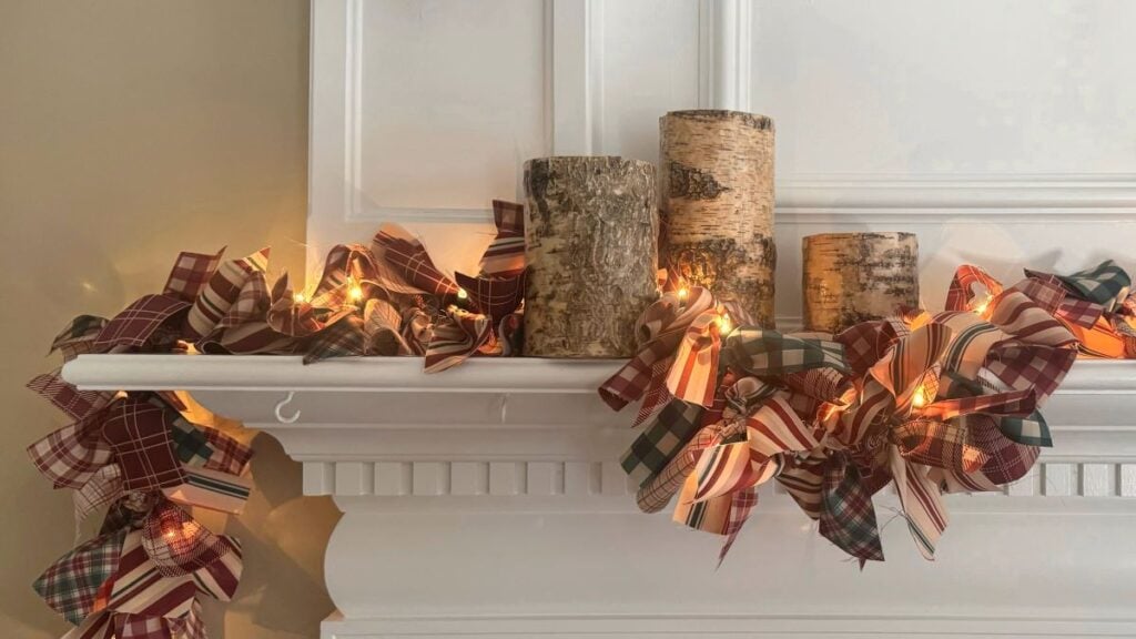 Close up of finished fabric lighted garland on a mantle with birch bark candles.