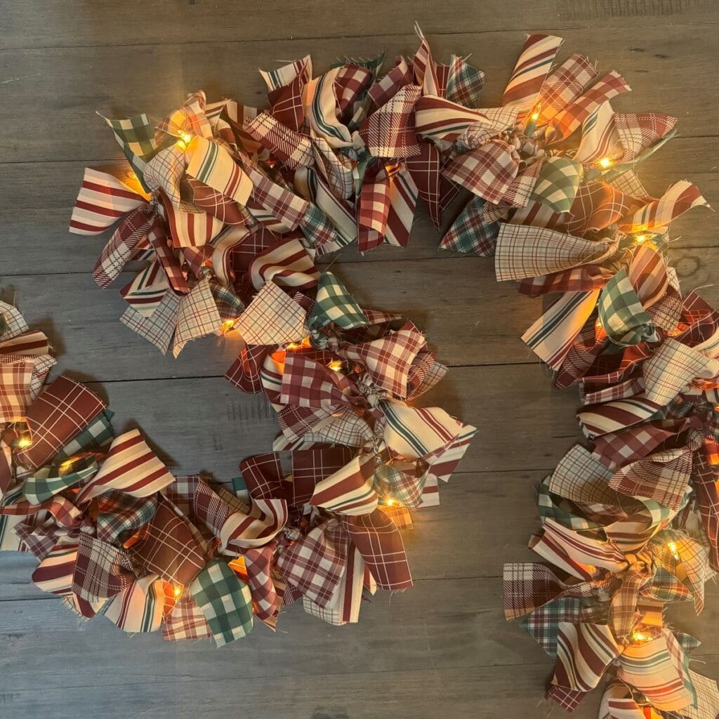 Completed Christmas garland laying on wooden table.