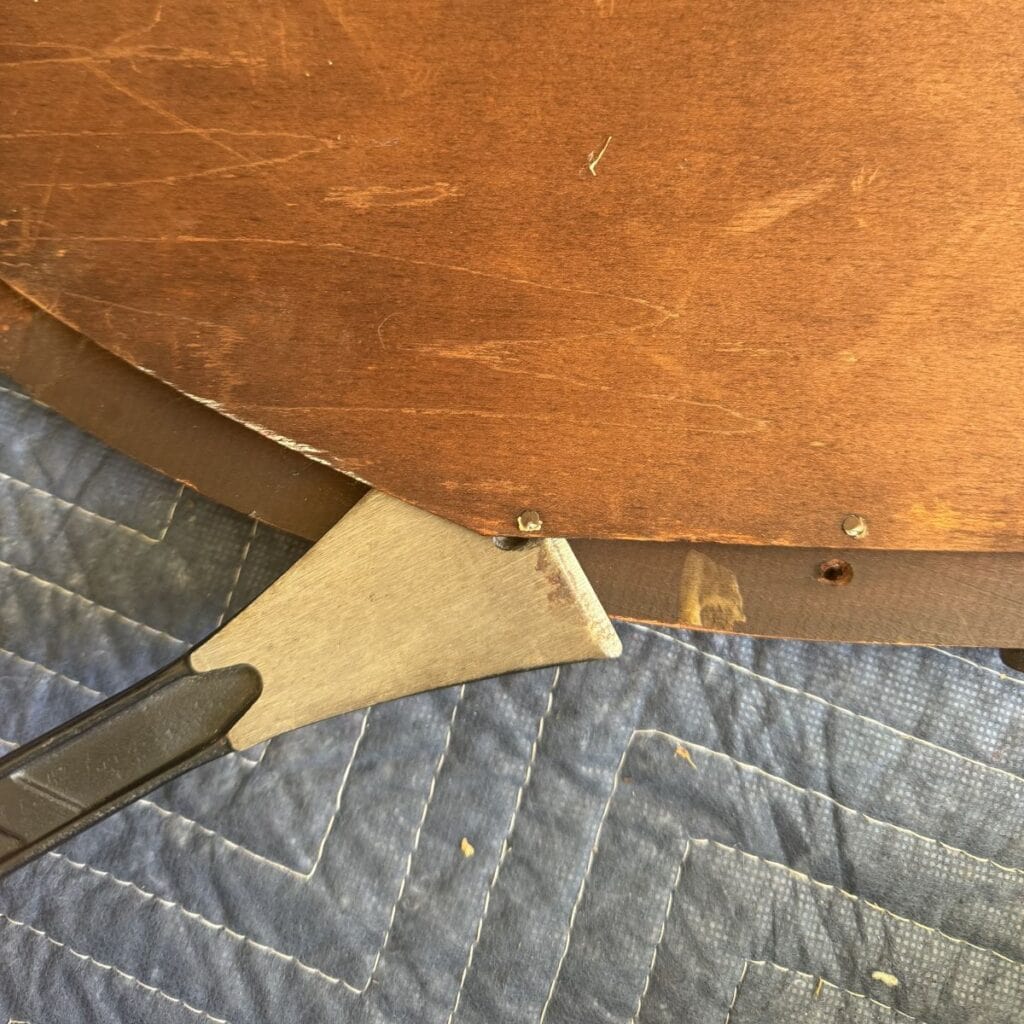 Removing nails from the mirror backing.