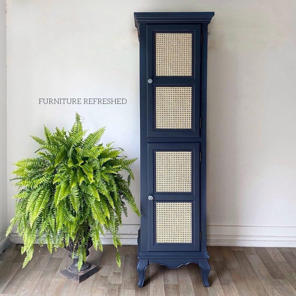 Tall navy cabinet with cane webbing added into the 4 door fronts.