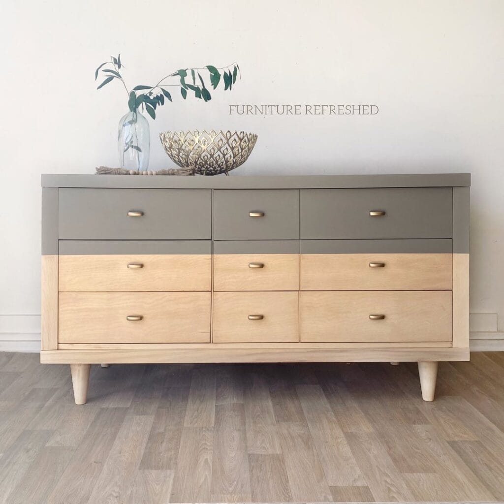 Photo of a dipped dresser. With raw sealed wood finish on the bottom 2/3 and gray paint on the top 1/3.