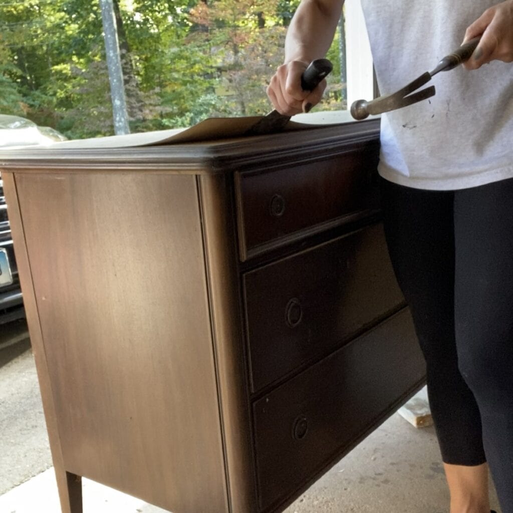 Removing veneer with a putty knife.