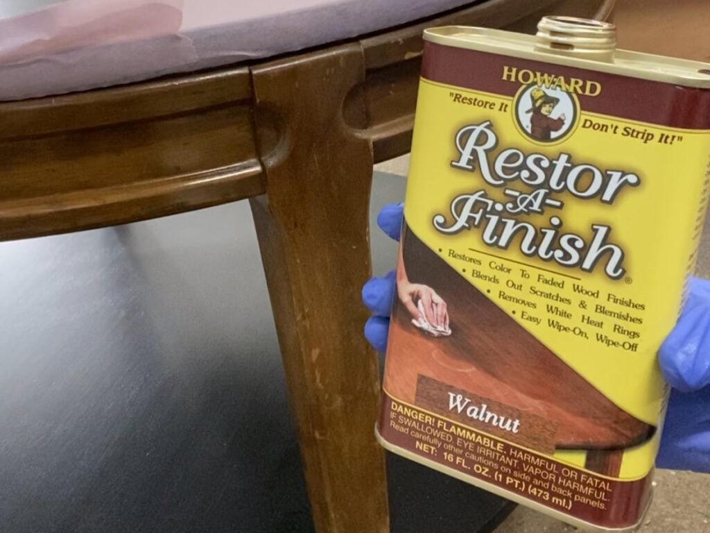 Photo showing a can of Howard's Restor-A-Finish next to a table leg with a worn finish.