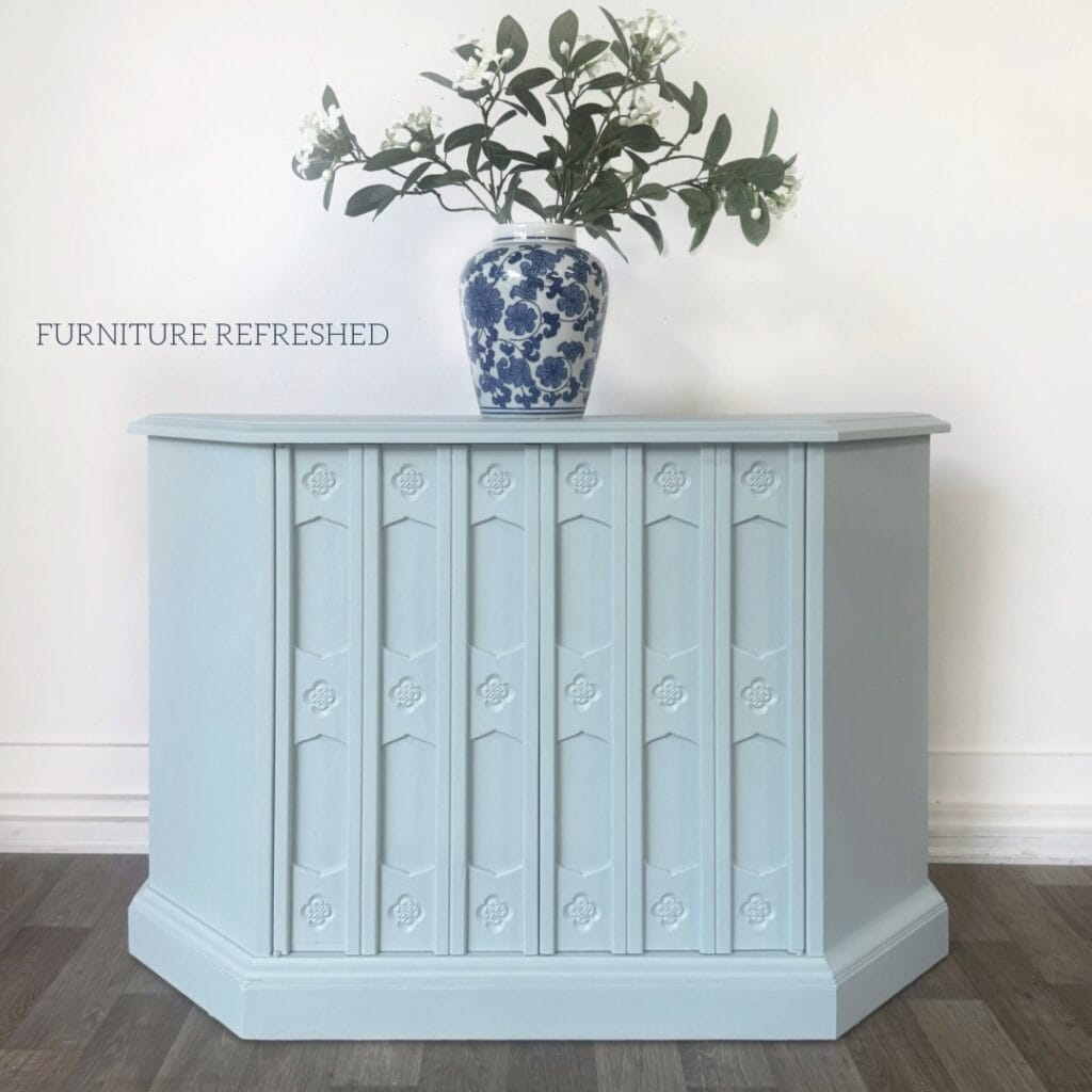 After photo of credenza painted in a light blue with green undertones.