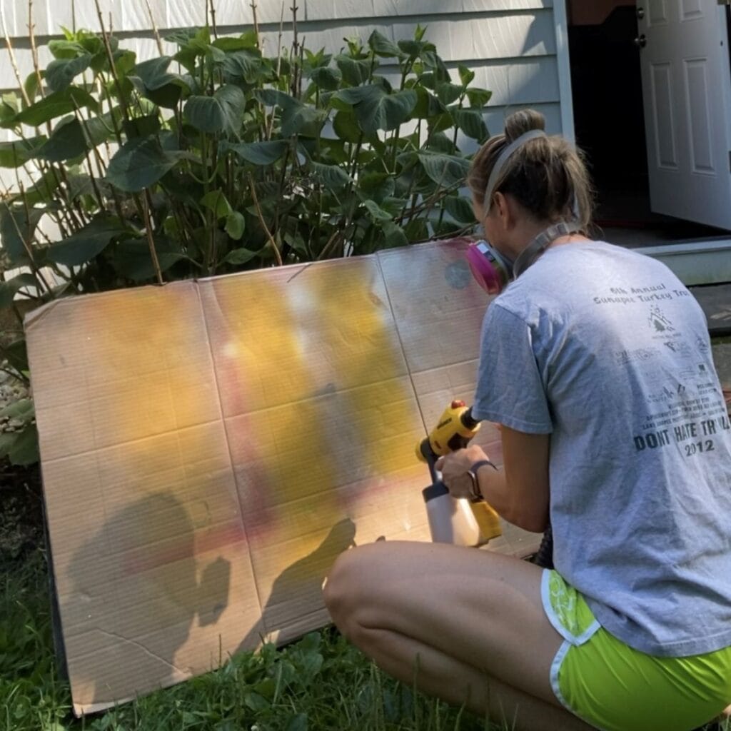 testing sprayer settings on a piece of cardboard